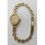 A 9ct gold Roamer ladies wristwatch with oval dial, weight including mechanism 11.8gms Condition