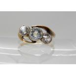 an 18ct ring set with three clear gems, size Q, weight 3.6gms Condition Report: Available upon