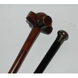 A silver-topped ebony walking cane and another walking cane (2) Condition Report: Available upon