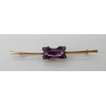 A 9ct gold brooch set with an unusual cut amethyst, length 6cm, weight 3.3gms Condition Report: