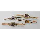 A 15ct gold amethyst and pearl brooch, length 6.2cm, weight 5.1gms and three 9ct gold amethyst,