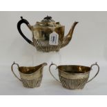 A three piece silver tea service with half ribbed body, Sheffield 1894, the teapot 14cm high (3),