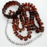 An amber coloured bead necklace and bracelet and a silver and aquamarine bracelet Condition