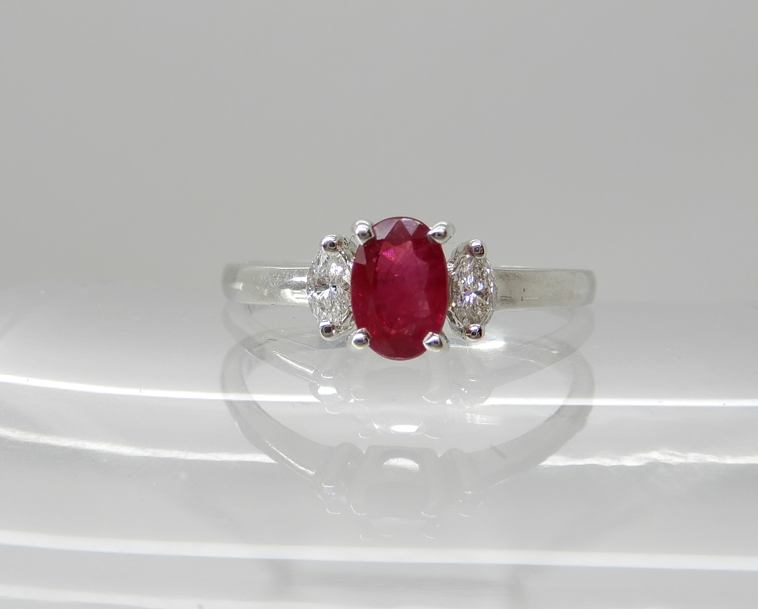 An 18ct white gold ruby and diamond ring, dimensions of the ruby 5.9mm x 4mm x 3.1mm, with marquis