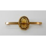 A bright yellow metal bar brooch set with a citrine, inscribed "Presented to Dr. John Steillby the