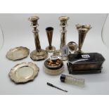 A lot comprising a pair of silver candlesticks (def), rubbed Birmingham marks, a pair of vases (