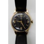 A 9CT GOLD GENTS TUDOR WRISTWATCH with black dial, luminous quarter Arabic numerals and batons,