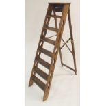 A VICTORIAN PINE STEP LADDER with seven steps joined with brass hinged arms, 155cm high Condition