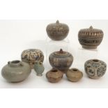 FOUR CHINESE SWATOW COVERED JARS painted with stylised flowers, 7 to 8cm high, vase, 6cm high,