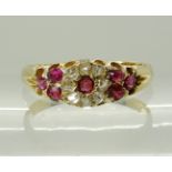 AN 18CT CONTINENTAL RUBY AND DIAMOND FLOWER RING set with rose cut diamonds, cushion and round cut