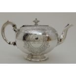 A VICTORIAN SILVER TEAPOT maker's mark unclear, London 1859 of squat spherical shape with engraved