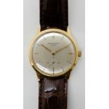 AN 18CT GOLD PATEK PHILIPPE WRISTWATCH with brushed silvered dial, gold coloured baton numeral and a