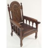 A VICTORIAN OAK GENTLEMAN'S CLUB ARMCHAIR the shield back carved with foliage joined to rexine