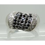 A 9CT WHITE GOLD BLACK AND WHITE DIAMOND DRESS RING finger size O, weight 7.1gms Condition Report: