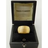 AN 18CT GOLD THEO FENNELL GOLD WHIP RING with all over reeded pattern, hallmarked London 2002,