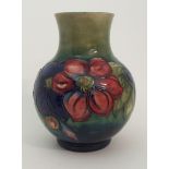 A MOORCROFT ANEMONE PATTERN VASE the bulbous body with green glaze and tube line decoration, 24cm