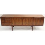 A MCINTOSH OF KIRKCALDY ROSEWOOD SIDEBOARD with two central cupboard doors flanked by three drawers