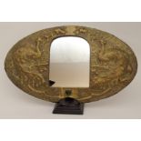 A GLASGOW SCHOOL BRASS ARTS AND CRAFTS MIRROR of oval form, with peacocks flanking the central