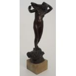 •THOMAS JOHN CLAPPERTON (SCOTTISH 1879-1962) bronze female nude, modelled standing on a rocky