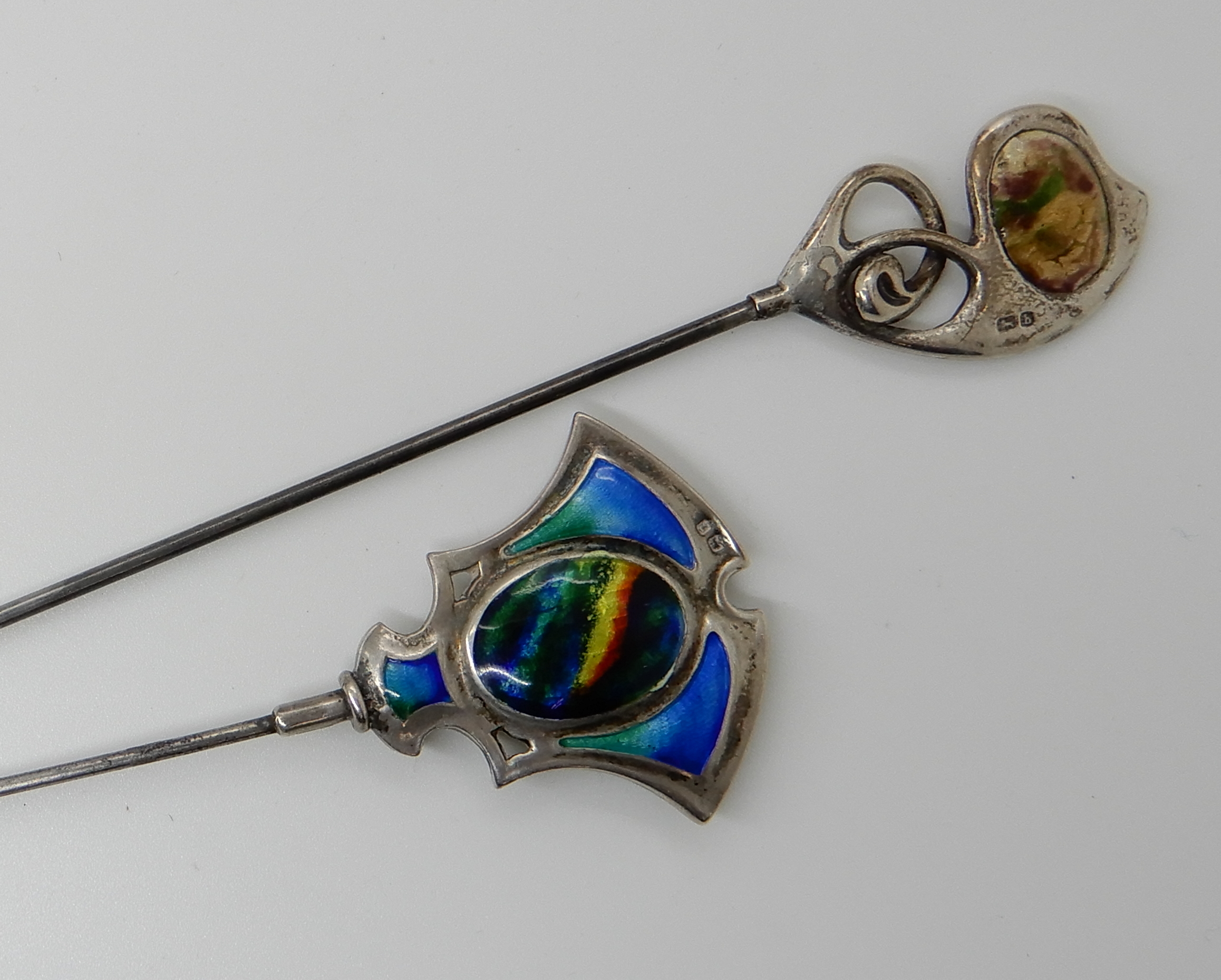 TWO SILVER AND ENAMEL ART NOUVEAU HATPINS enamelled in purple and green hallmarked for Birmingham