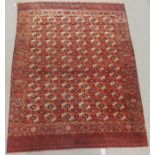 A TERRACOTTA GROUND TURKMEN RUG 290cm x 220cm Condition Report: Available upon request