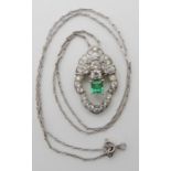 A WHITE METAL DIAMOND AND EMERALD PENDANT set with a step cut emerald approx dimensions 4.5mm x 4.
