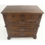 AN OAK PANELLED CHEST ON CHEST with two drawers above two drawers with raised angular drawer