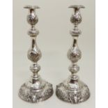 A PAIR OF SILVER CANDLESTICKS by Rubin Kushir, London 1905, the removable drip pans on bulbous
