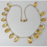 A STRING OF SEED PEARLS WITH CITRINE PENDANTS largest citrine approx 16.6mm x 11.9mm, smallest