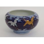 A FUKAGAWA BOWL the exterior painted with herons on a gilt cloud scroll ground above crashing