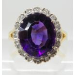 AN 18CT GOLD AMETHYST AND DIAMOND CLUSTER RING the amethyst is approx 12mm x 10mm x 6.3mm, further