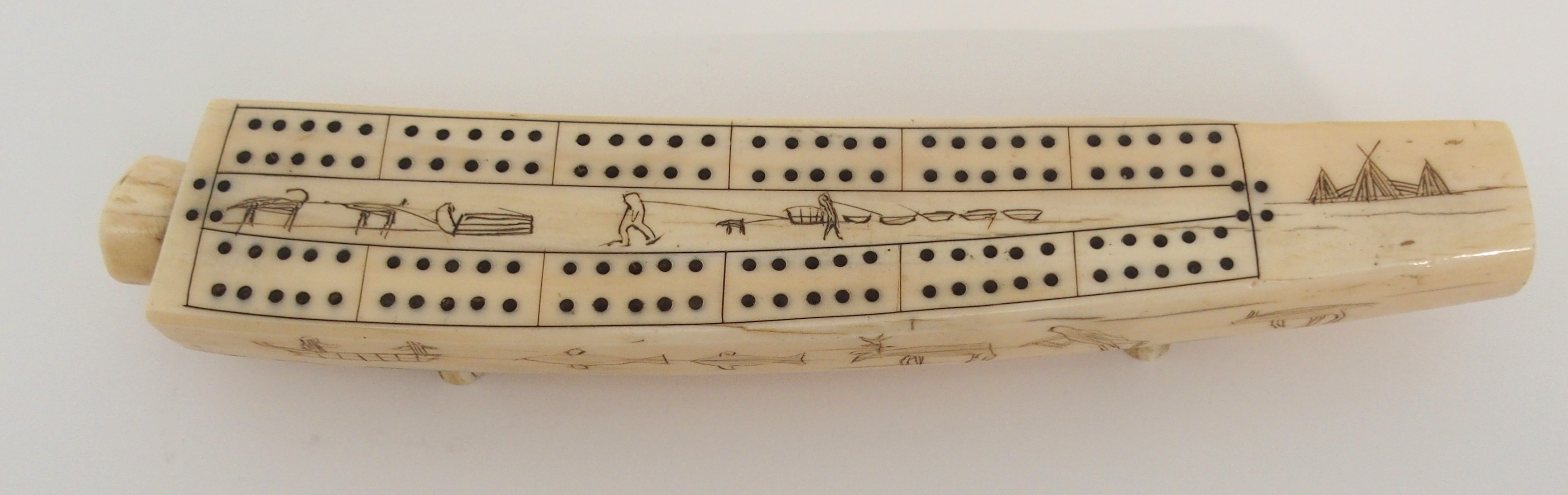 AN INUIT WALRUS TUSK CRIBBAGE BOARD the top with twelve pierced marker sections, divided by Eskimos, - Image 2 of 6