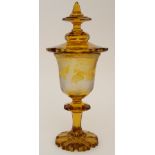 A BOHEMIAN AMBER FLASHED GOBLET AND COVER with etched decoration of deer in a landscape setting,