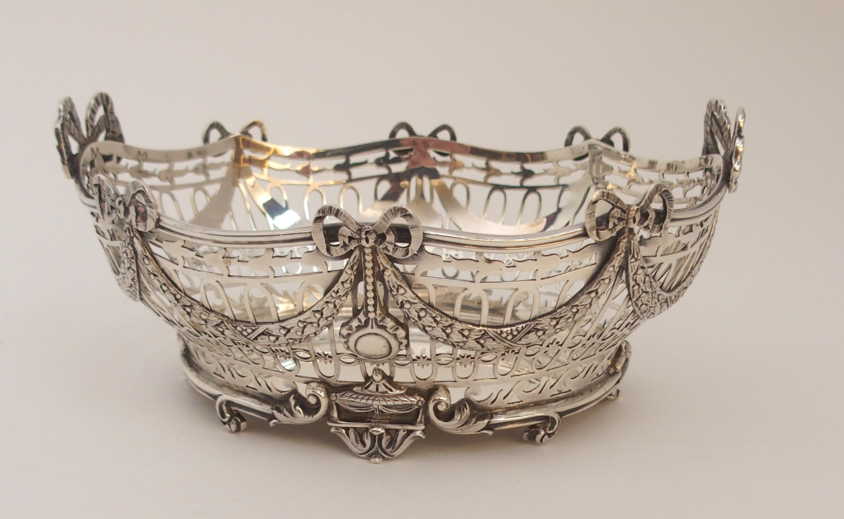 A SILVER BASKET by C. S. Harris & Sons Limited, London 1912, of oval form, the open strapwork body