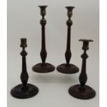 A PAIR OF TURNED GEORGIAN MAHOGANY CANDLESTICKS with brass mounts 32.5cm high together with