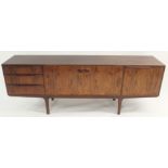 A MCINTOSH OF KIRKCALDY ROSEWOOD SIDEBOARD with a pair of central doors flanked by three drawers and