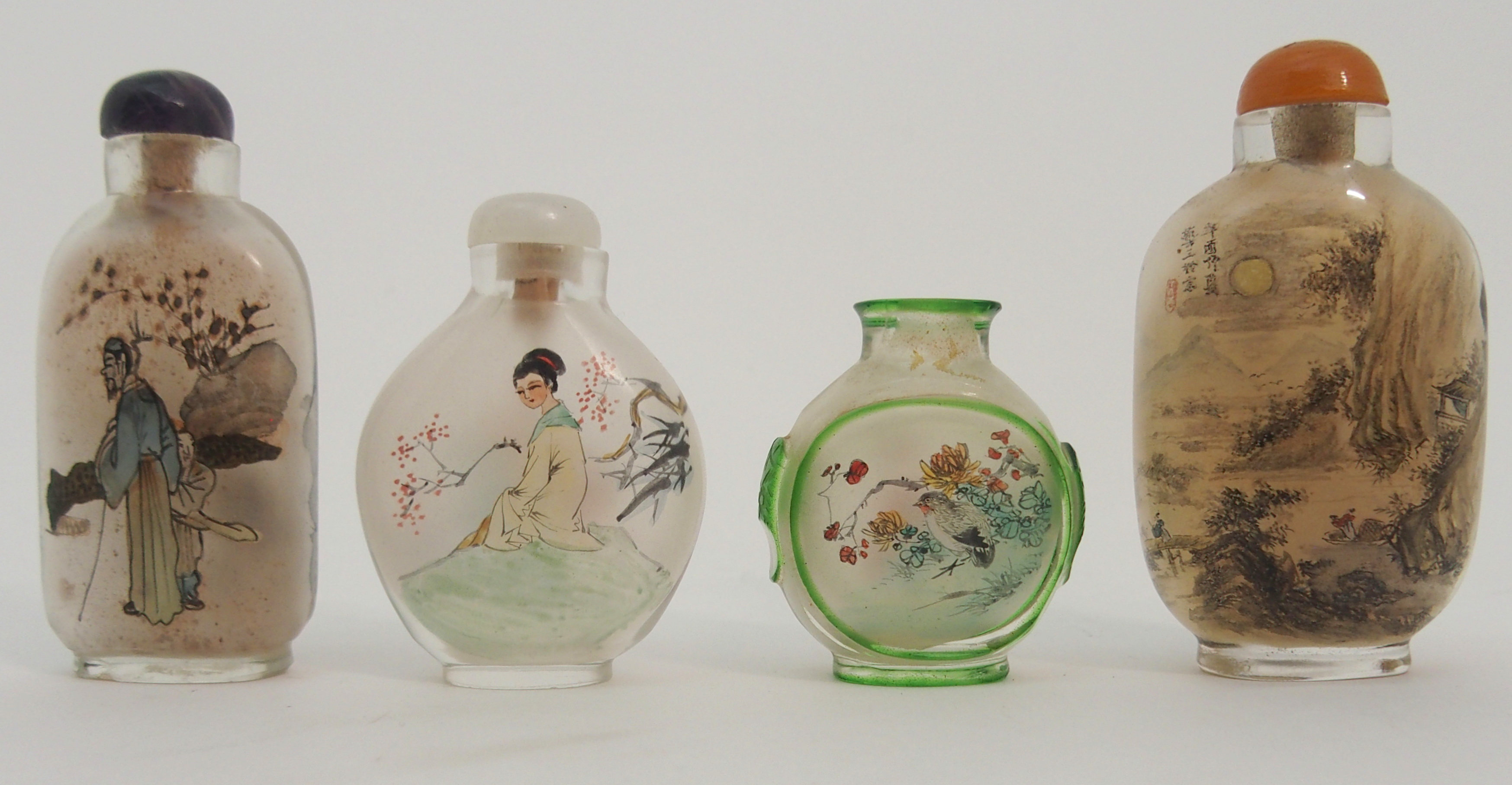 FOUR CHINESE DECORATED GLASS SNUFF BOTTLES one with a river landscape, scholar and attendant, 7cm