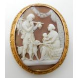 A LARGE SHELL CAMEO BROOCH OF A FAMILY GROUP mounted in yellow metal, Etruscan design mount with