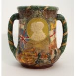 A ROYAL DOULTON SILVER JUBILEE LOVING CUP designed by Charles Noke and commemorating George V and