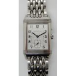 A STAINLESS STEEL JAEGER LE COULTRE NIGHT & DAY REVERSO WATCH with a white 'day' metallic dial
