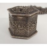 AN ASIAN WHITE METAL HEXAGONAL BOX cast with grotesque animal, the pierced sliding case with