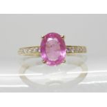 A 14K GOLD PINK SAPPHIRE AND DIAMOND RING set with a 1.40ct pink sapphire with diamonds set tot