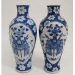 A PAIR OF CHINESE BLUE AND WHITE BALUSTER VASES painted with panels of precious objects within