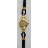 AN 18CT GOLD LADIES ROLEX PRECISION WATCH with chevron and dot numerals to the patterned dial and