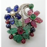 A TUTTI FRUITI BROOCH craftsman made in white metal, and set with foliate carved sapphires,