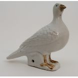 A CHINESE EXPORT MODEL OF A PIGEON modelled with the bird seated on rockwork and detailed with brown