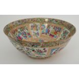 A CANTON FAMILLE ROSE PUNCH BOWL painted with numerous figures on pavilions and divided by gilt
