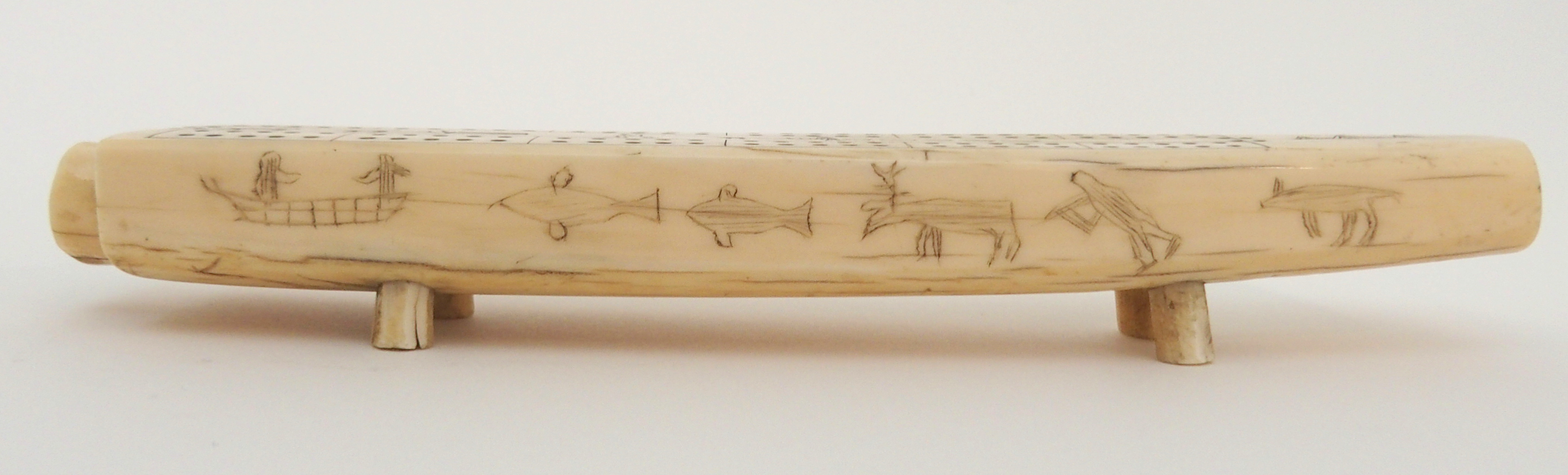 AN INUIT WALRUS TUSK CRIBBAGE BOARD the top with twelve pierced marker sections, divided by Eskimos, - Image 3 of 6