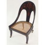 A REGENCY EBONISED AND GILT SLIPPER CHAIR the arched back gilt with anthemion leaf and rosettes