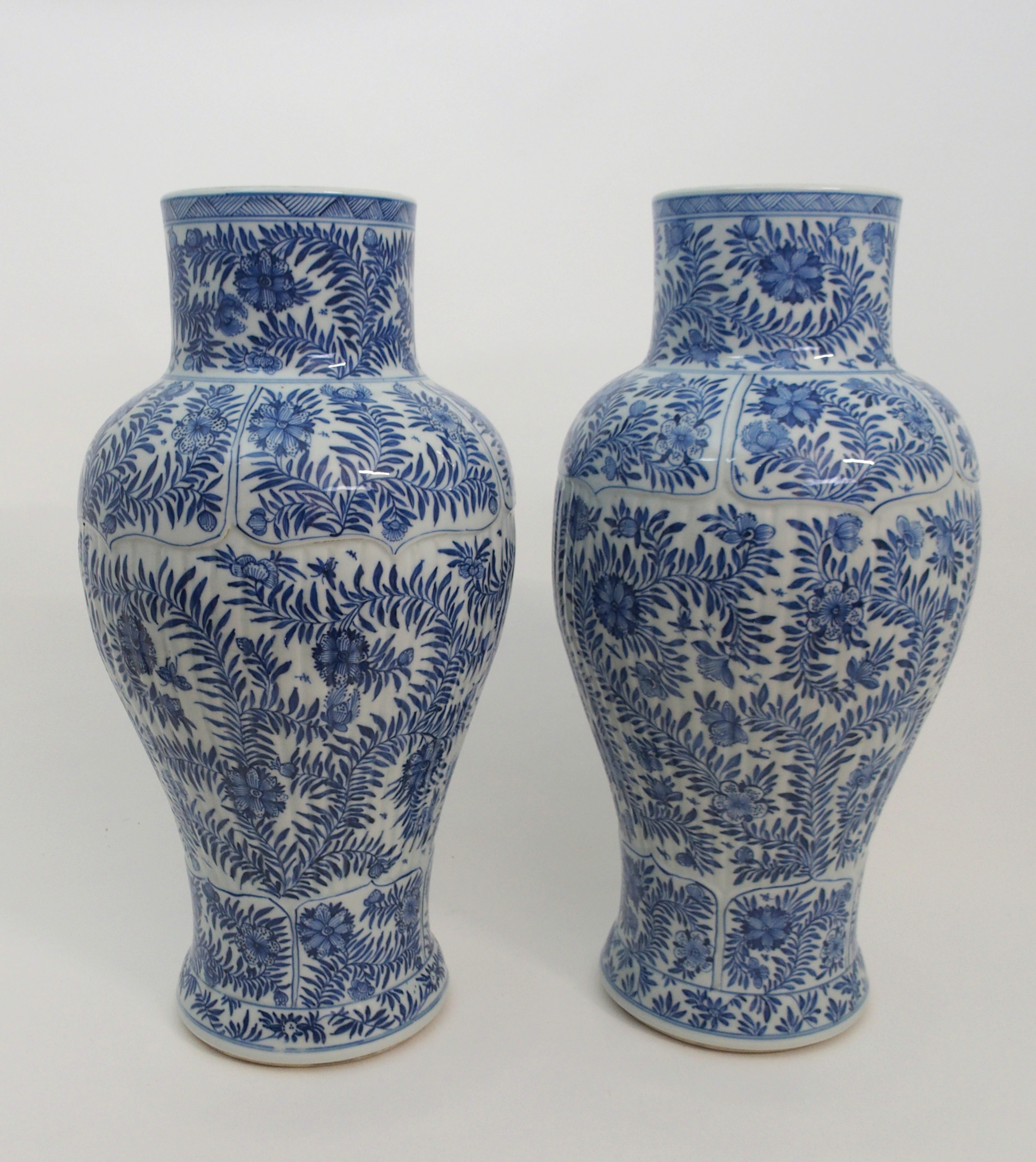 A PAIR OF CHINESE BLUE AND WHITE MOULDED BALUSTER VASES AND A COVER painted with panels of flowers - Image 6 of 12